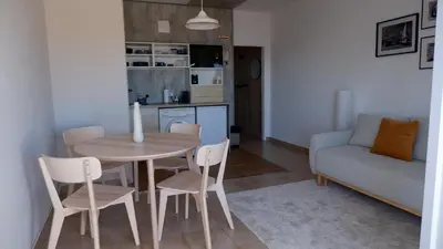 a living room with a table and chairs and a couch at Pipos d'Al-buhera in Albufeira