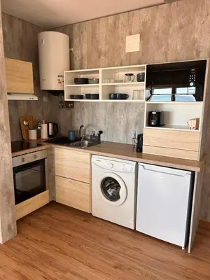 a kitchen with a washing machine and a washer at Pipos d'Al-buhera in Albufeira