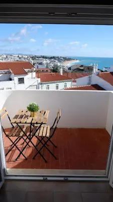 a patio with a table and chairs on a balcony at Pipos d'Al-buhera in Albufeira