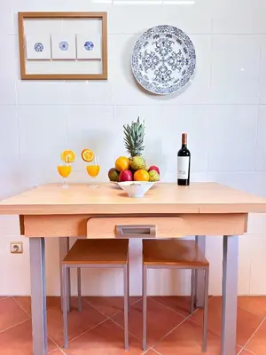 a table with two glasses of wine and a bowl of fruit at Balaia Maggs House Pool & Ocean view by BeCherish in Albufeira