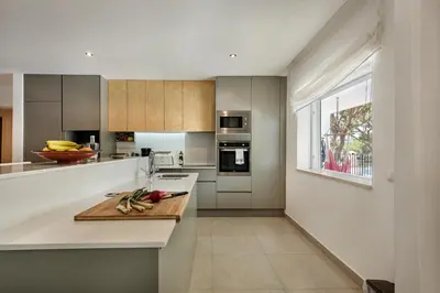 a kitchen and living room with a couch and a table at Casa Florida in Almancil
