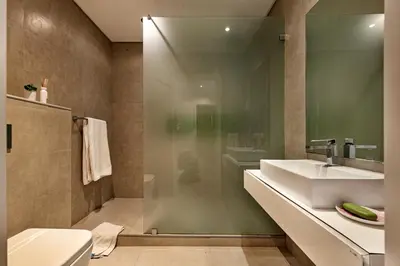 a bathroom with a sink and a glass shower at Casa Florida in Almancil