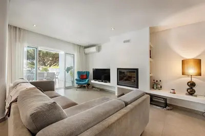 a large living room with a couch and a tv at Casa Florida in Almancil