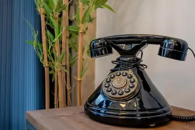 a telephone sitting on a table next to a vase at The Warehouse - Industrial Loft in Faro