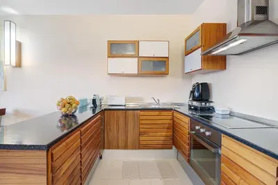 a kitchen with a table and chairs and a counter at Paraiso do Atlantico in Albufeira