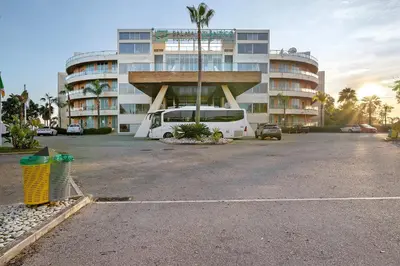 a van parked in a parking lot in front of a building at Paraiso do Atlantico in Albufeira