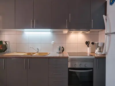 a kitchen with a sink and a stove at Akivillas Quarteira Cool in Quarteira