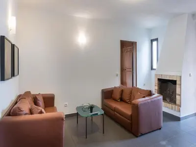 a living room with two couches and a fireplace at Akivillas Quarteira Cool in Quarteira