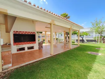 a covered patio with a large television on a house at ABF62 confortavel T2 a 2,5km praia Gale in Galé