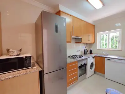 a kitchen with a stainless steel refrigerator and a dishwasher at ABF62 confortavel T2 a 2,5km praia Gale in Galé