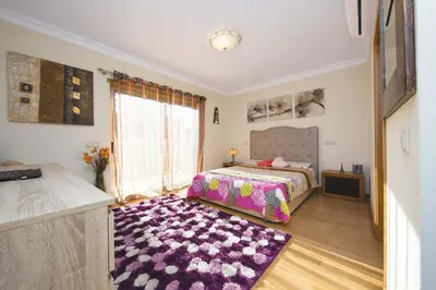 a bedroom with a bed and a purple rug at ABF38, encantadora Villa V4 em lugar sossegado in Guia