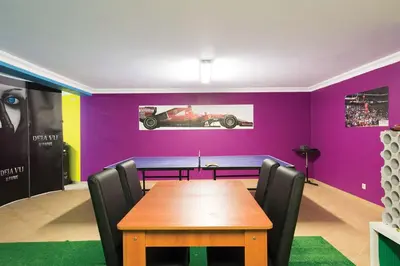 a dining room with a table and a purple wall at ABF38, encantadora Villa V4 em lugar sossegado in Guia