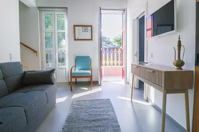a living room with a couch and a table at Faro Old Town Apartments in Faro