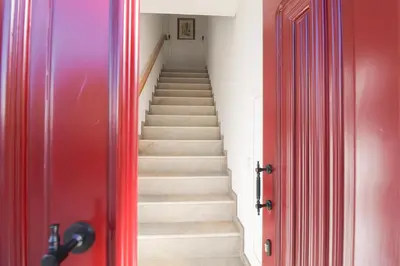 a balcony of a building with a red door at Faro Old Town Apartments in Faro