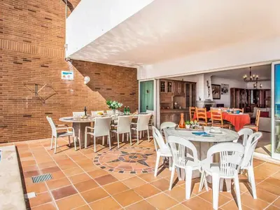 a room with tables and chairs and a brick wall at Holiday Home Chalet Villa Oceano mit privatem Pool by Interhome in Albufeira