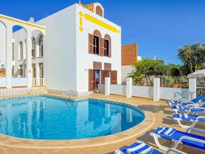 a swimming pool with chairs and a building at Holiday Home Chalet Villa Albuar mit eigenem Pool by Interhome in Albufeira