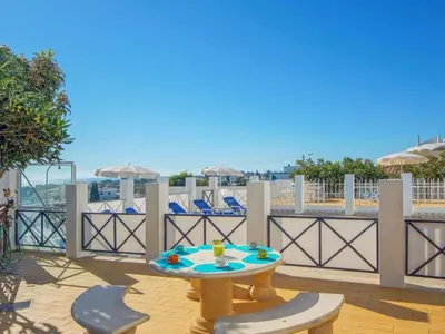 a patio with a table and chairs on a balcony at Holiday Home Chalet Villa Albuar mit eigenem Pool by Interhome in Albufeira