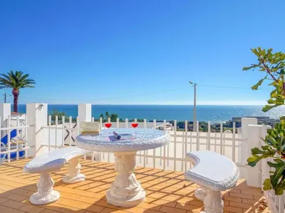 a patio with a table and chairs and the ocean at Holiday Home Chalet Villa Albuar mit eigenem Pool by Interhome in Albufeira