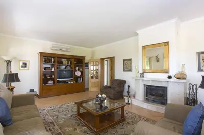 a living room with a couch and a fireplace at Villa Anthony by Villa Plus in Terras Novas