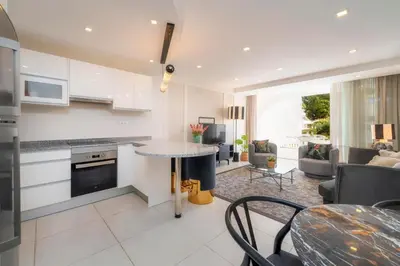 a kitchen and living room with a table and chairs at Casa do Gil, Vale do Lobo Beach and Golf in Loulé