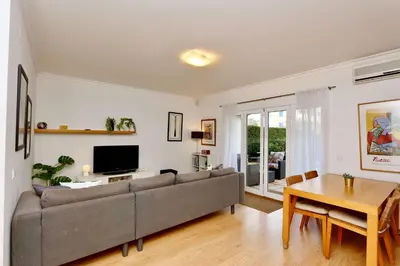a living room with a couch and a table at Melias apartment - Cleverdetails, Vilamoura in Vilamoura