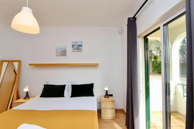 a bedroom with a bed and a large window at Melias apartment - Cleverdetails, Vilamoura in Vilamoura