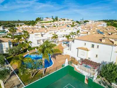 an aerial view of a villa with a swimming pool at Margarida Apartment - Ping pong table in Albufeira