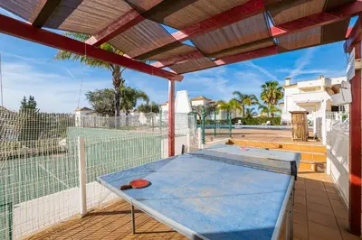a ping pong table on the back porch of a house at Margarida Apartment - Ping pong table in Albufeira