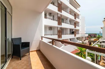 a balcony with a chair and a view of the ocean at Rocco del Mar by Portucasa in Albufeira