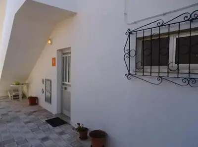a building with a balcony on the side of it at Blife Delya private rooms at Faro beach in Faro