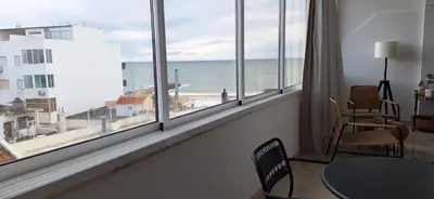 a room with a window with a view of the ocean at Casa Cardoso in Quarteira