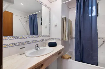 a bathroom with a sink and a mirror and a tub at Lotus Villa, Albufeira in Albufeira