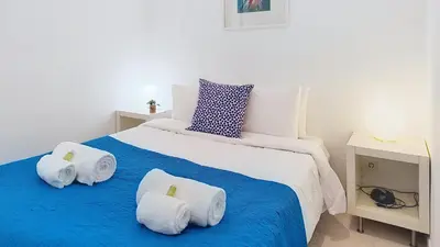 a kitchen with a table with a counter top with a microwave at Vilamar T0 in Vilamoura