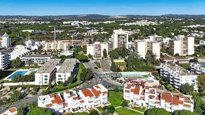 an aerial view of a city with buildings and the ocean at Vilamar T0 in Vilamoura