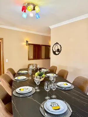 a dining room with a black table and chairs at Villa Sun & Shine in Faro