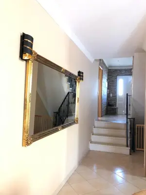 a mirror on the wall of a hallway with stairs at Villa Sun & Shine in Faro
