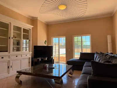 a living room with a couch and a coffee table at Villa Sun & Shine in Faro