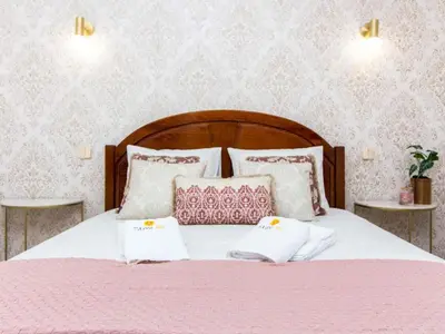 a bed with pink and white pillows on it at Algarve Sun by Stay ici - Algarve Holiday Rental in Albufeira