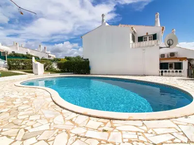 a swimming pool in front of a house at Algarve Sun by Stay ici - Algarve Holiday Rental in Albufeira