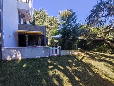 a house with a white fence in the yard at T2 Apartment with private garden in the Balaia Apartments, Albufeira, Algarve in Atalaia