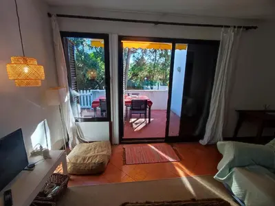 a porch with a white fence next to a house at T2 Apartment with private garden in the Balaia Apartments, Albufeira, Algarve in Atalaia