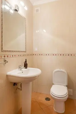 a bathroom with a sink and a tub and a toilet at Central Albufeira Stay | Balcony & AC in Albufeira