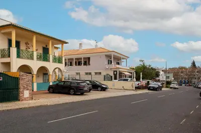 a kitchen with wooden cabinets and a stove top oven at Central Albufeira Stay | Balcony & AC in Albufeira