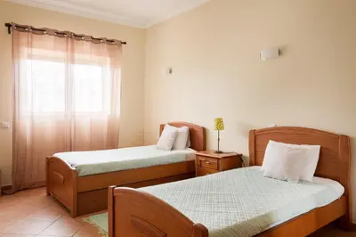 a living room with a blue couch and a table at Central Albufeira Stay | Balcony & AC in Albufeira