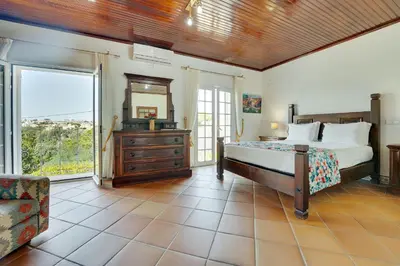 a bedroom with a bed and a window at Villa das Buganvilias by Delilah Collection in Albufeira
