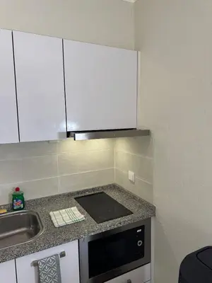 a small kitchen with a sink and a microwave at Relaxing studio in Albufeira Jardim in Albufeira