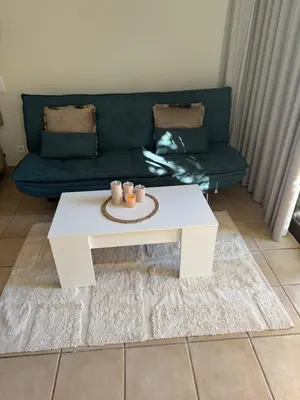 a living room with a couch and a white coffee table at Relaxing studio in Albufeira Jardim in Albufeira