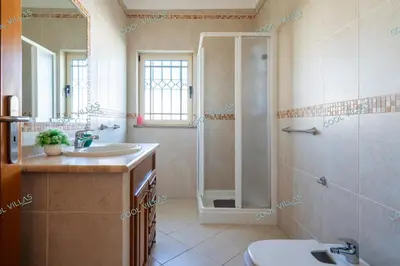 a bathroom with a shower sink and a toilet at Villa Cibel - Beach & Golf 10pax in Guia