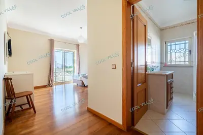 a living room with a door open to a bedroom at Villa Cibel - Beach & Golf 10pax in Guia