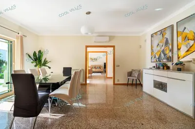 a dining room and living room with a table and chairs at Villa Cibel - Beach & Golf 10pax in Guia